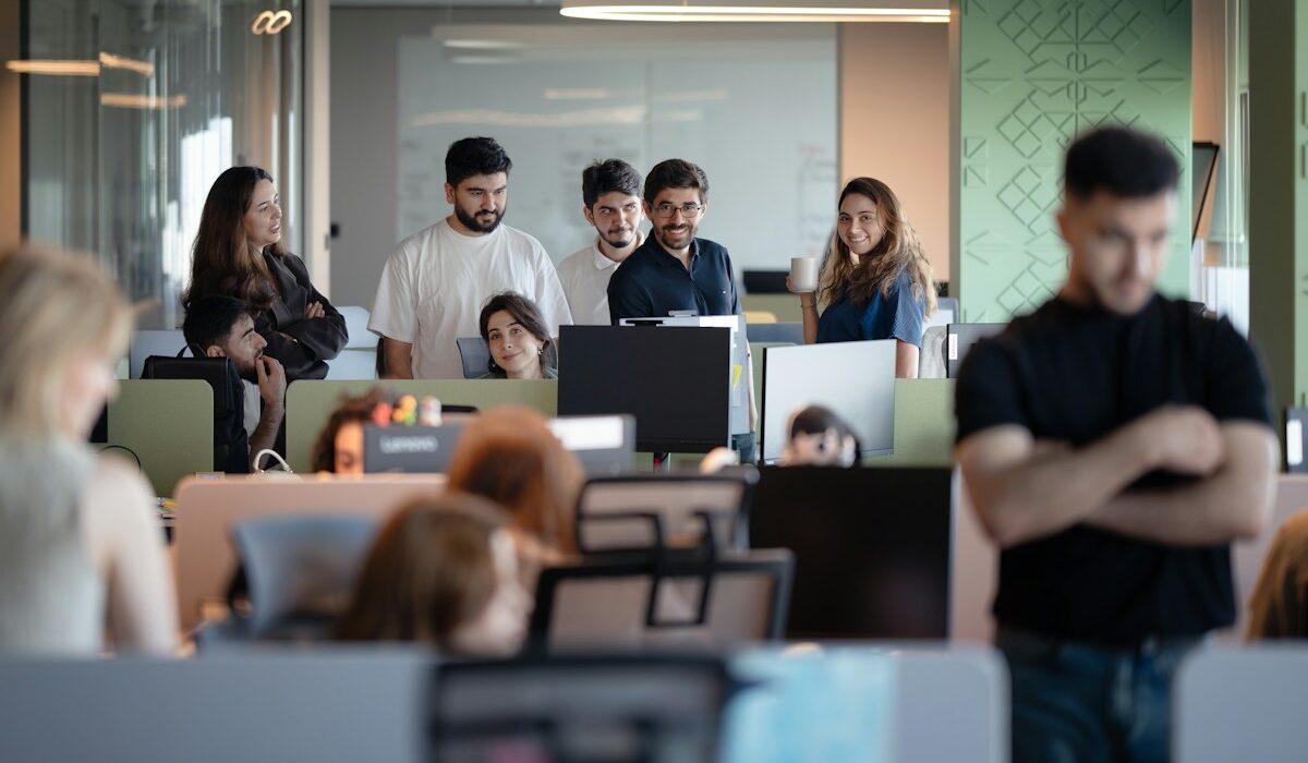 Anthropic AI agent hours in an office workplace with employees and computer screens