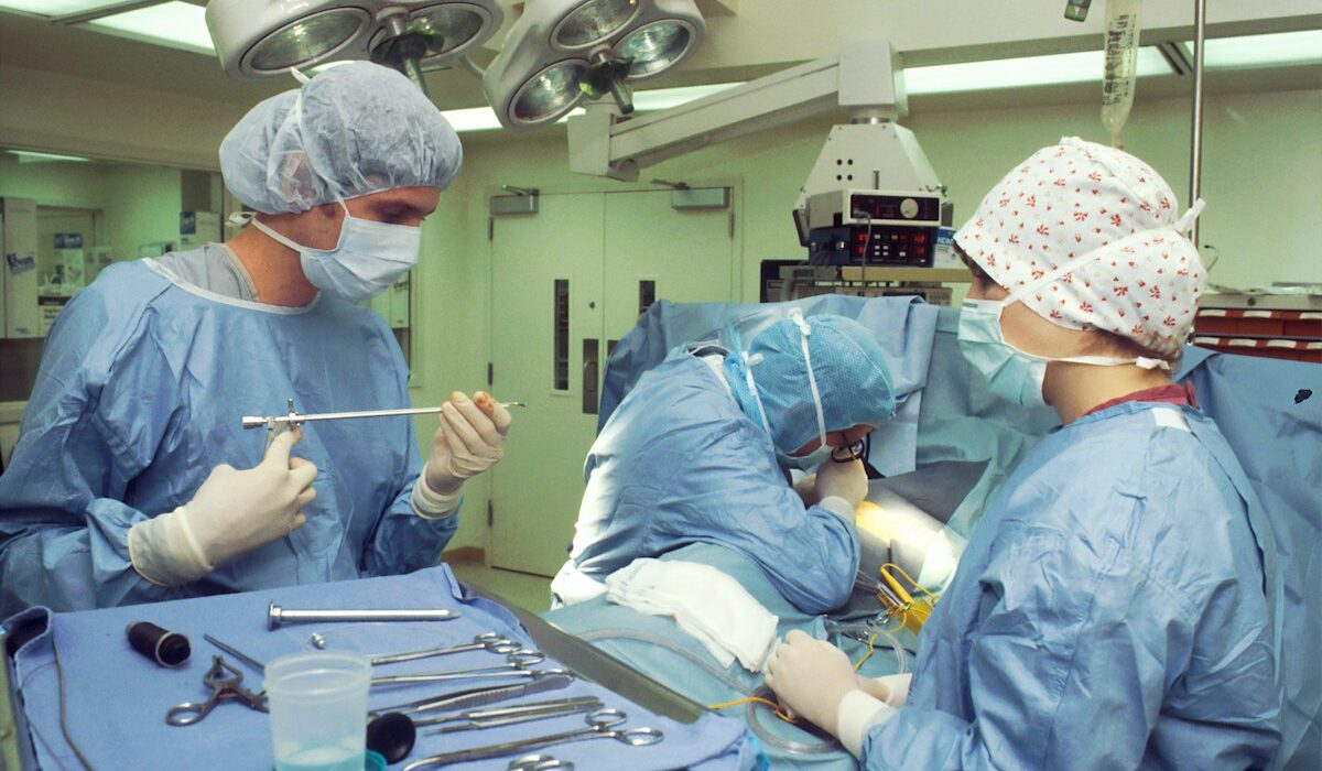 AngioDynamics earnings story illustrated by a surgical team using medical instruments in an operating room.