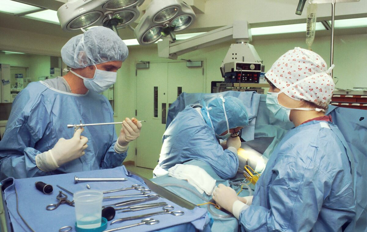 AngioDynamics earnings story illustrated by a surgical team using medical instruments in an operating room.
