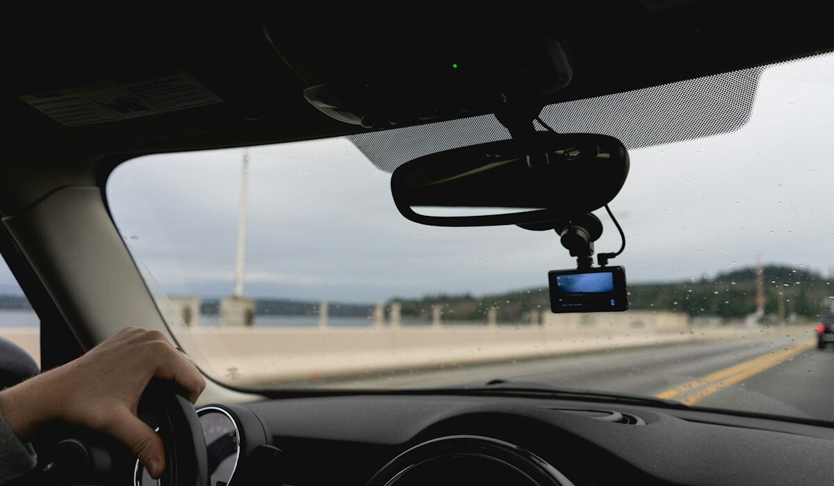 Driver using an advanced vehicle system on a highway, illustrating Mobileye autonomous-driving technology