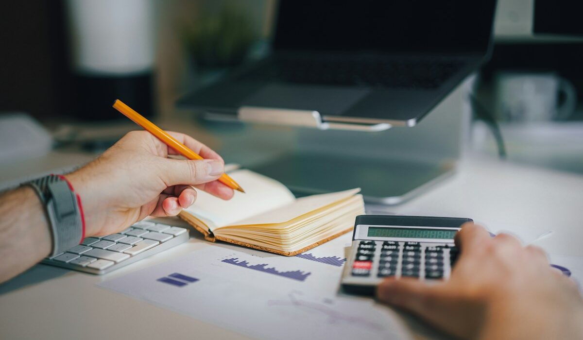 Balance sheet explained with a calculator and financial documents on a desk