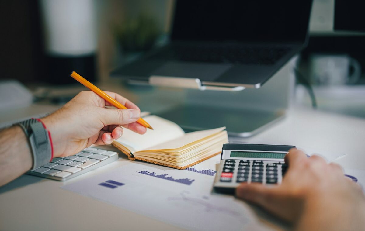 Balance sheet explained with a calculator and financial documents on a desk