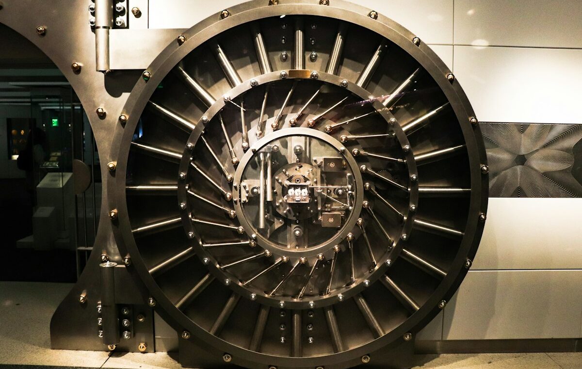 Bank failure backstops illustrated by a large steel bank vault door used to secure financial assets.