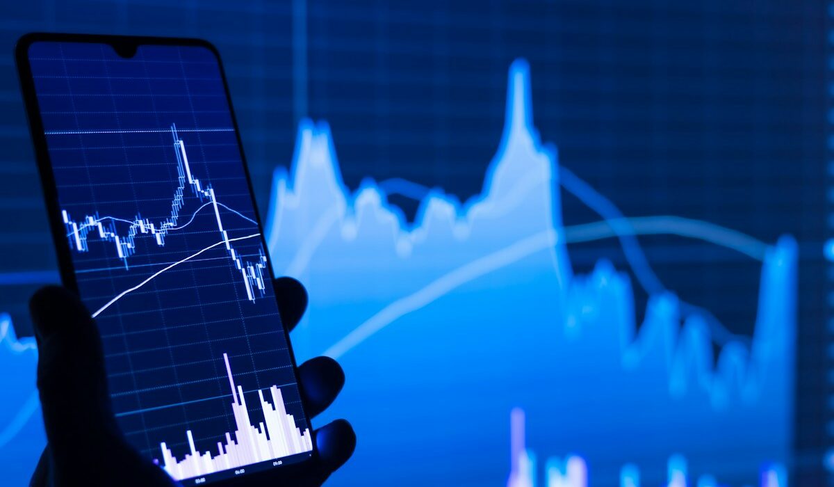 Smartphone displaying a market chart representing Binance bStocks margin collateral