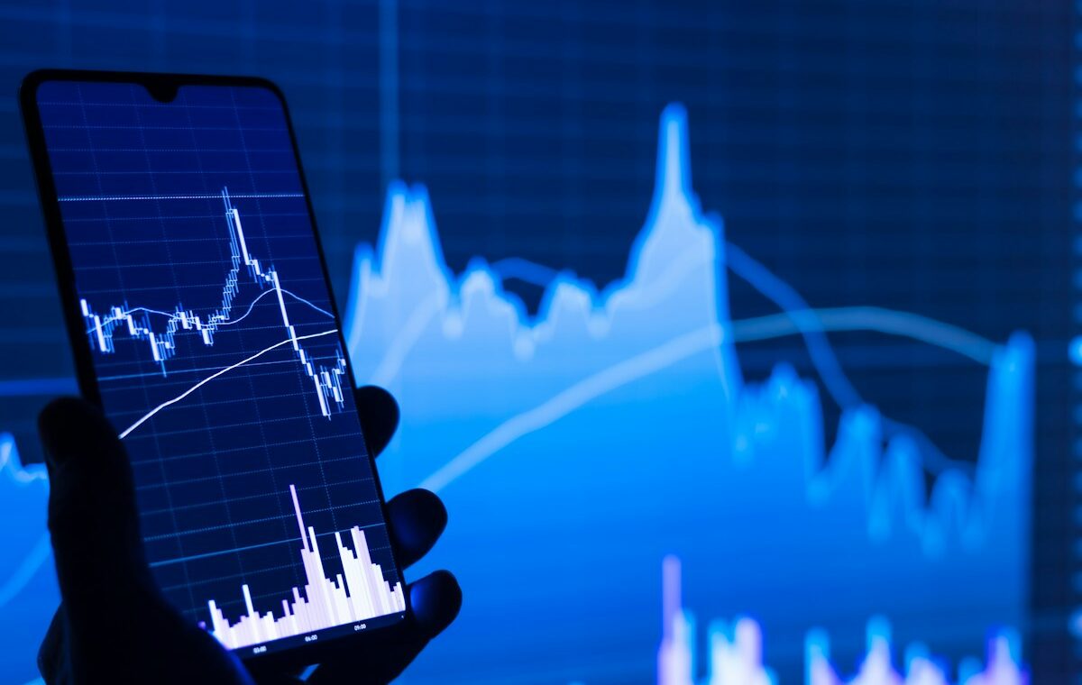 Smartphone displaying a market chart representing Binance bStocks margin collateral