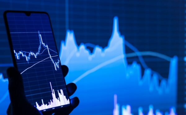 Smartphone displaying a market chart representing Binance bStocks margin collateral