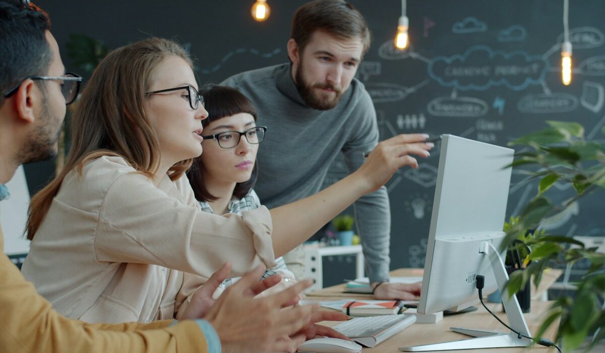 Business team reviewing AI-generated recommendations on a desktop computer