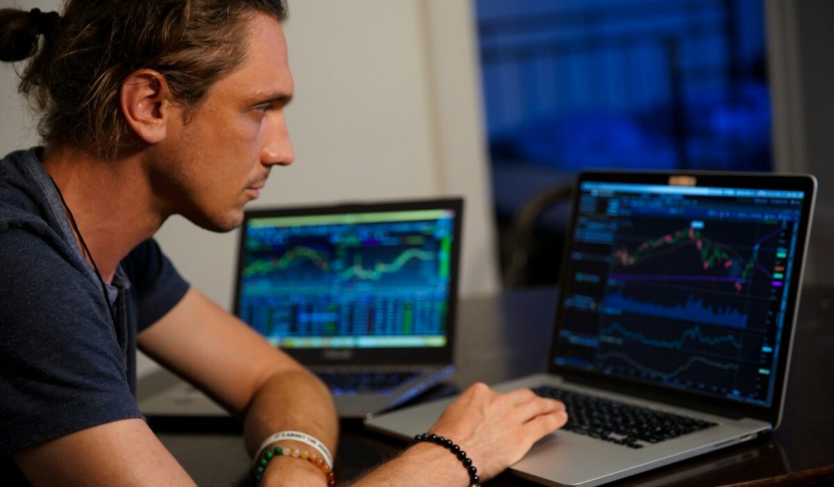 Trader viewing market charts representing record CME Group revenue and volume