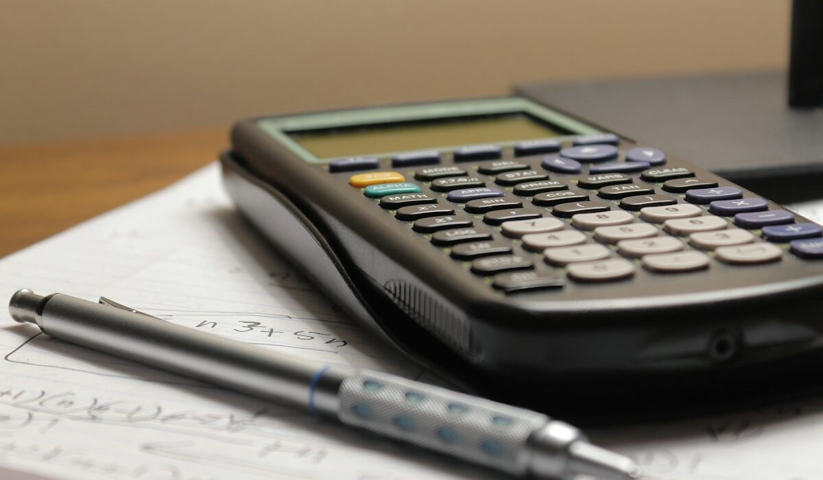 Book value per share calculation with a calculator, pen and financial notes