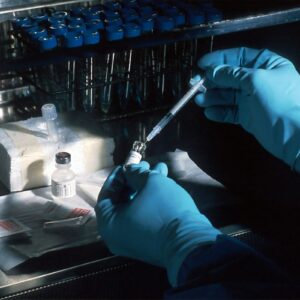 Scientist preparing cancer research material in a sterile laboratory