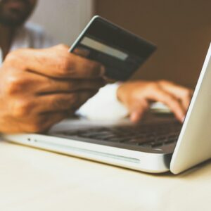 Person using a credit card and laptop for online banking