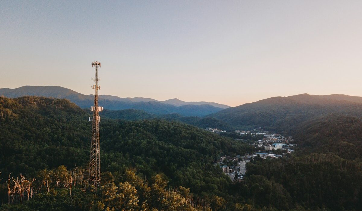 Cell tower overlooking a mountain community at sunset