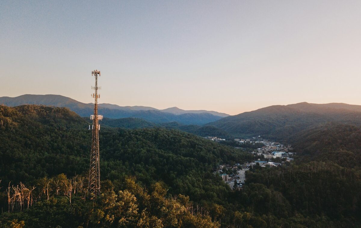 Cell tower overlooking a mountain community at sunset