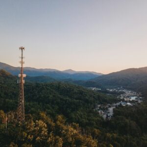 Cell tower overlooking a mountain community at sunset