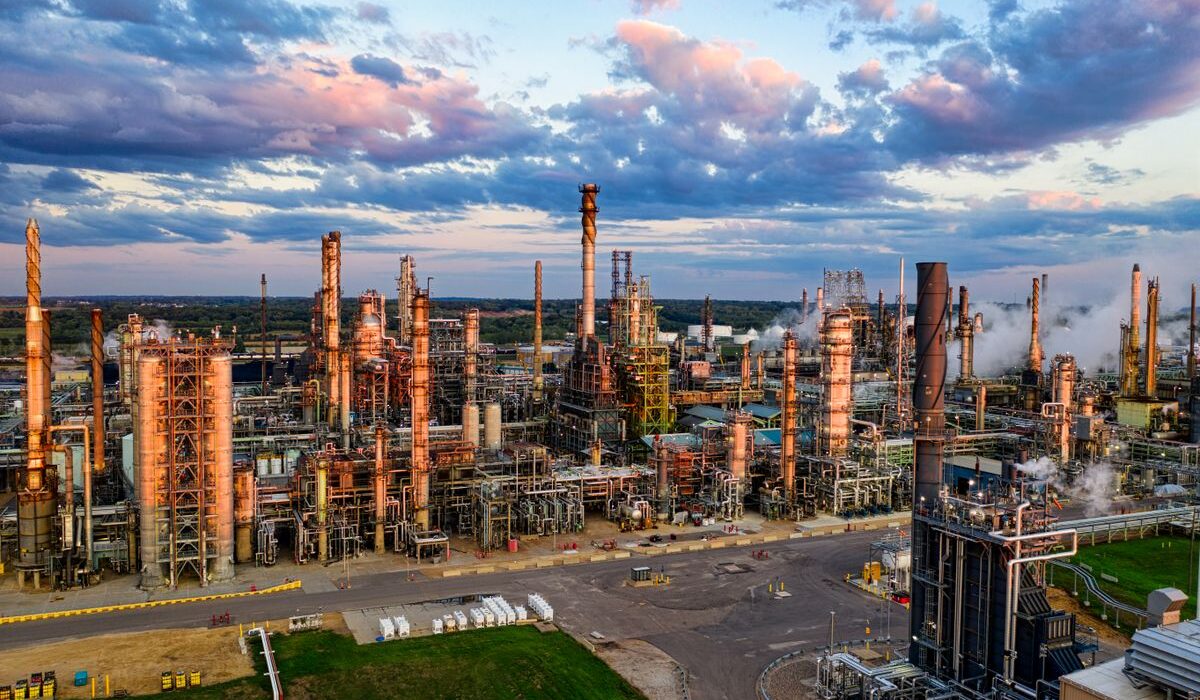 Oil refinery complex at sunset ahead of Chevron third-quarter earnings