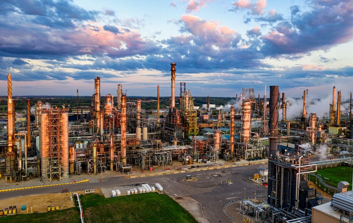 Oil refinery complex at sunset ahead of Chevron third-quarter earnings