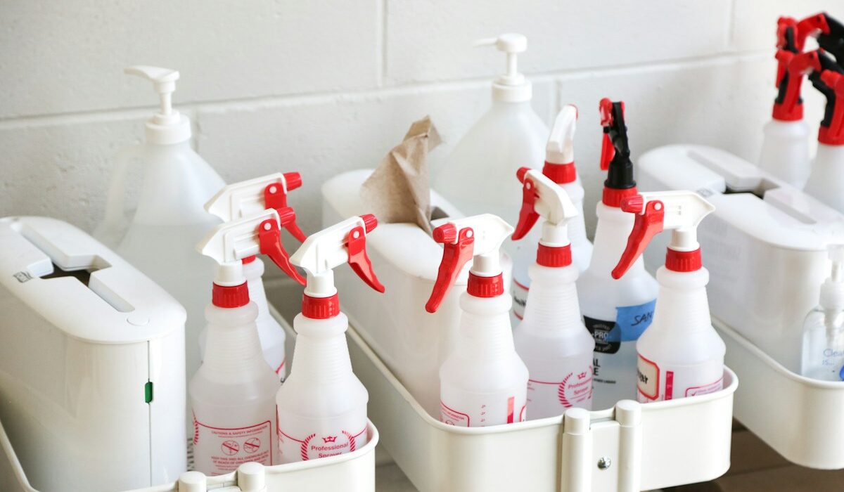 Rows of consumer cleaning products in white spray bottles