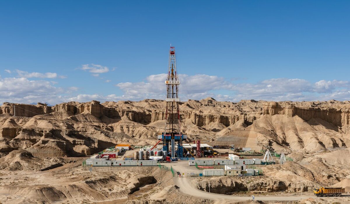 Crescent Energy offering represented by an oil drilling rig in an arid field