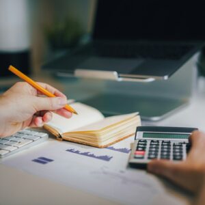 Investor calculating dividend payout ratio from financial reports