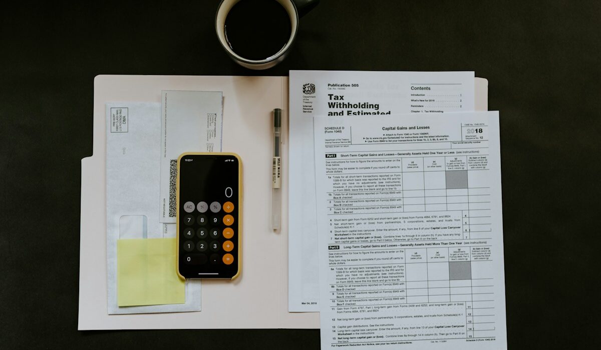 Calculator and tax documents used to evaluate dividend yield income