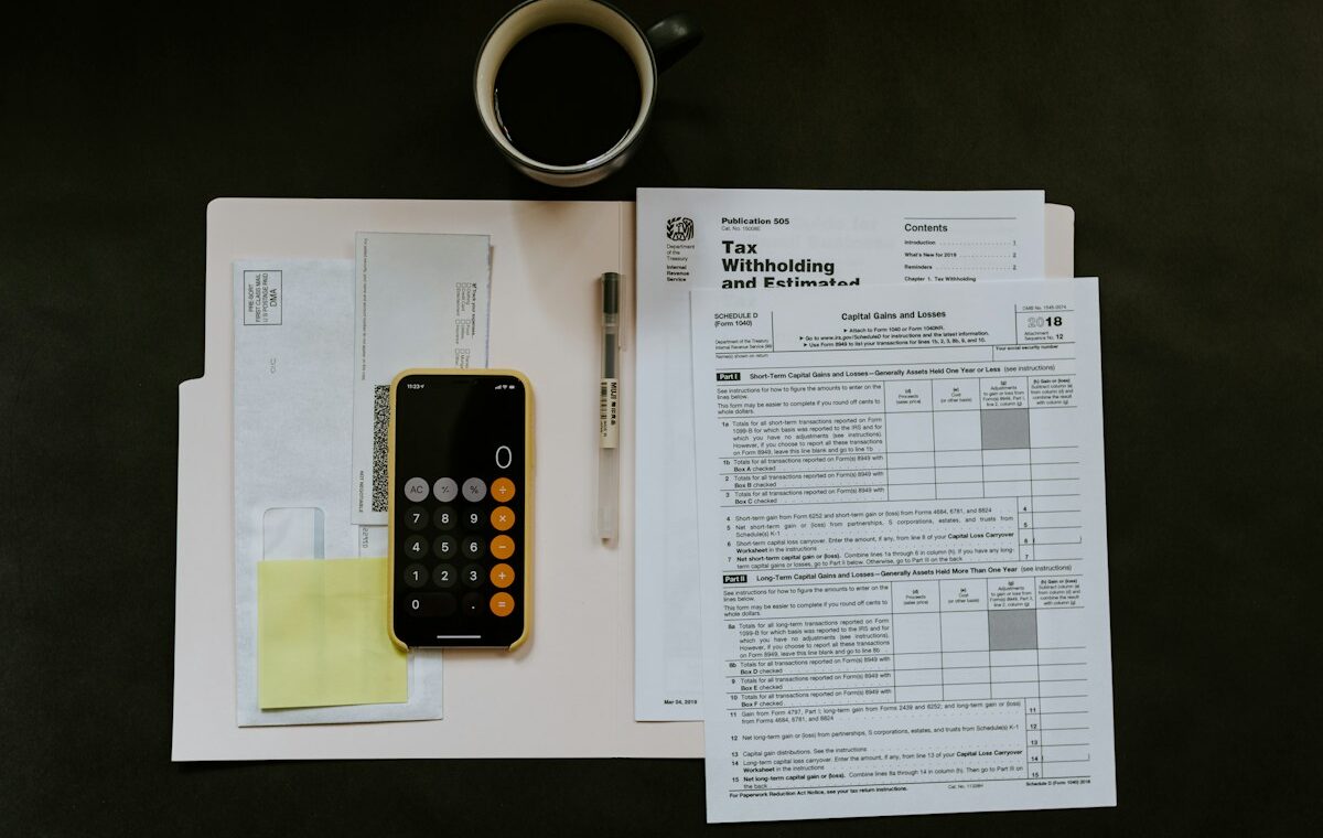 Calculator and tax documents used to evaluate dividend yield income