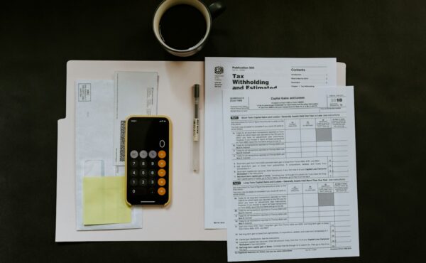 Calculator and tax documents used to evaluate dividend yield income
