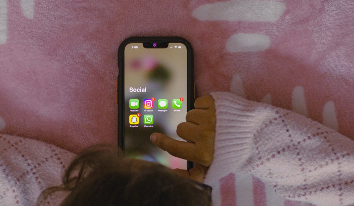 EU KIDS Act online safety represented by a child using a smartphone