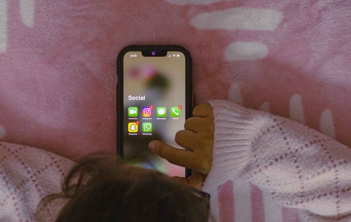 EU KIDS Act online safety represented by a child using a smartphone