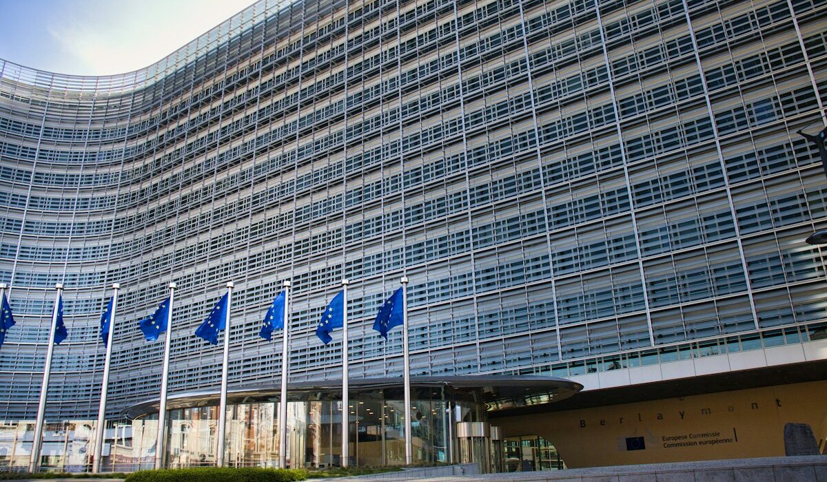 European Union flags outside an institutional building illustrating EU stablecoin regulation