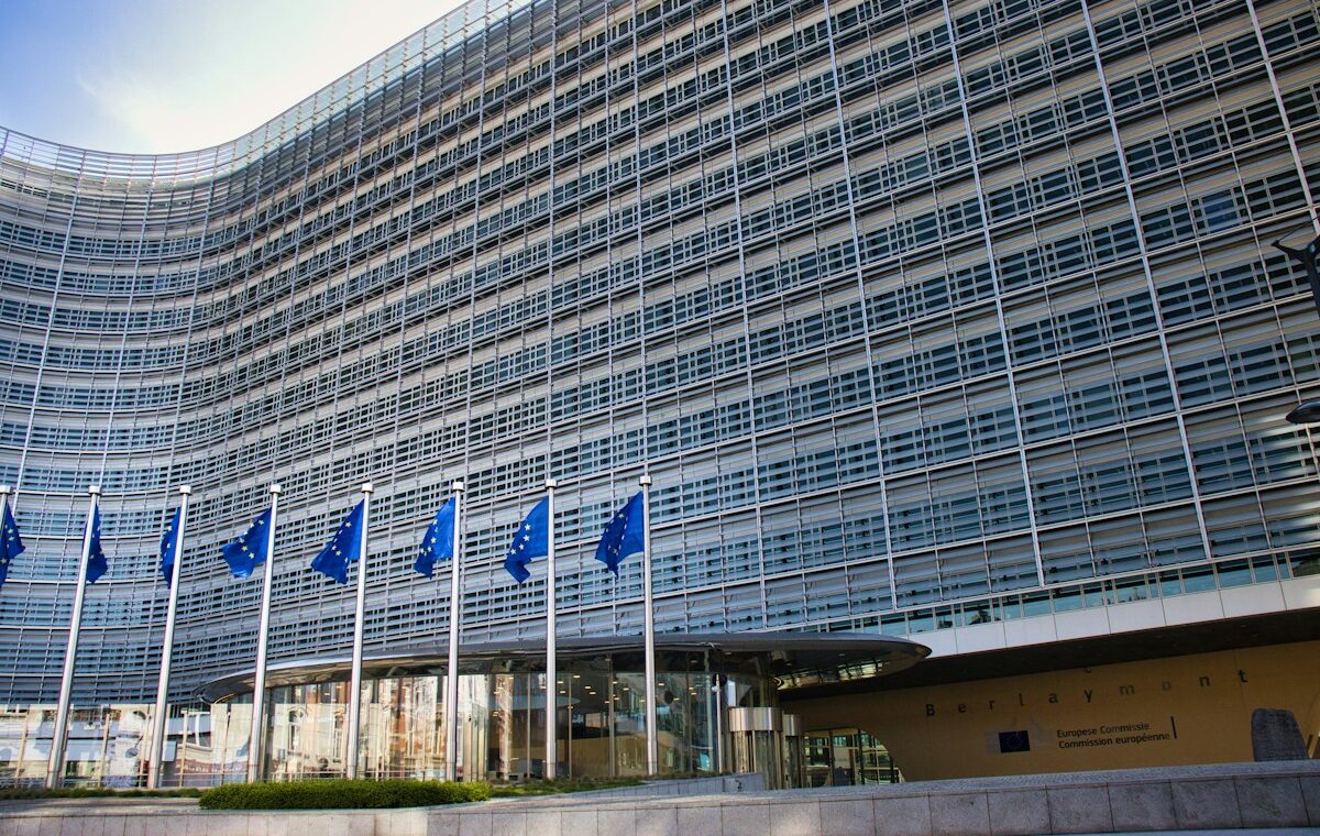 European Union flags outside an institutional building illustrating EU stablecoin regulation