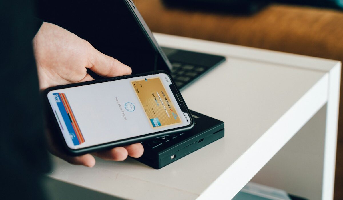 A smartphone using an embedded digital wallet at a payment terminal