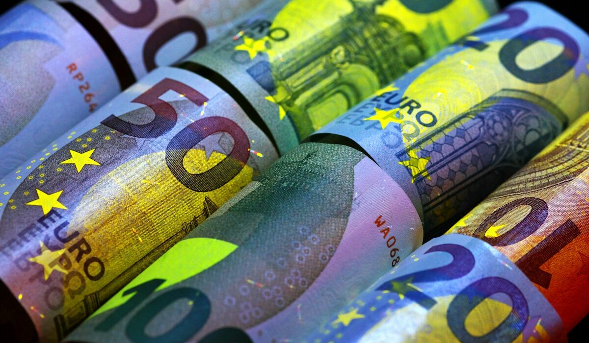 Rolled euro banknotes illustrating Qivalis's planned euro stablecoin