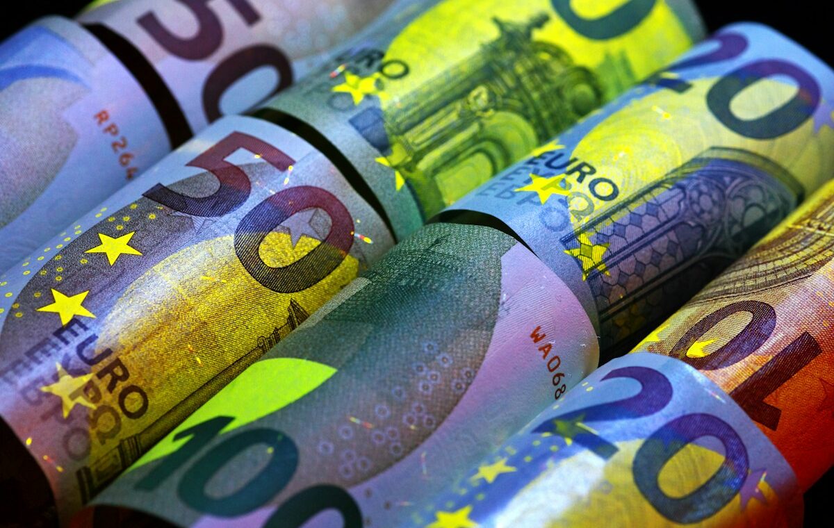 Rolled euro banknotes illustrating Qivalis's planned euro stablecoin