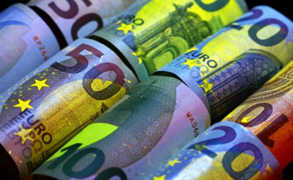 Rolled euro banknotes illustrating Qivalis's planned euro stablecoin