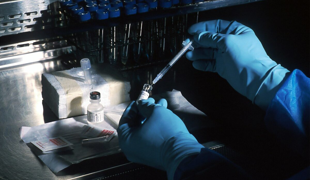 Scientist preparing a cancer vaccine sample in a sterile laboratory