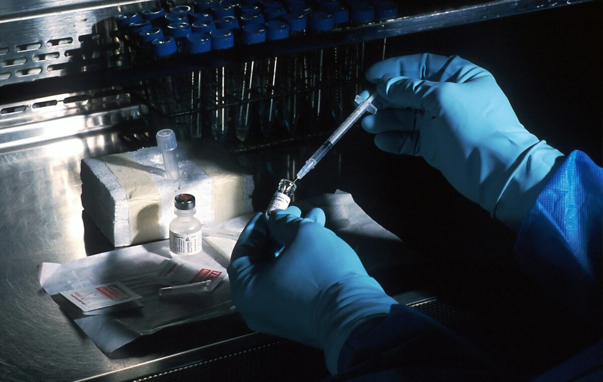 Scientist preparing a cancer vaccine sample in a sterile laboratory