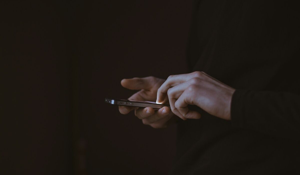 Person using a smartphone as Facebook adds AI algorithm feed controls