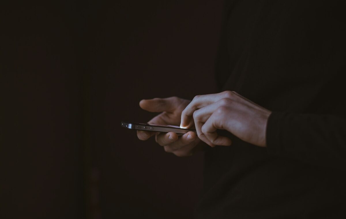Person using a smartphone as Facebook adds AI algorithm feed controls
