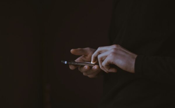 Person using a smartphone as Facebook adds AI algorithm feed controls