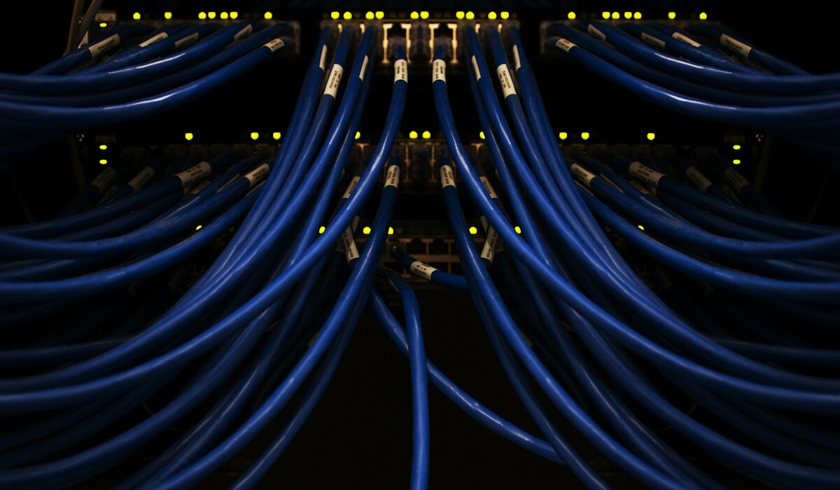 Blue network cables connected to data-center equipment, representing Nokia AI and cloud infrastructure
