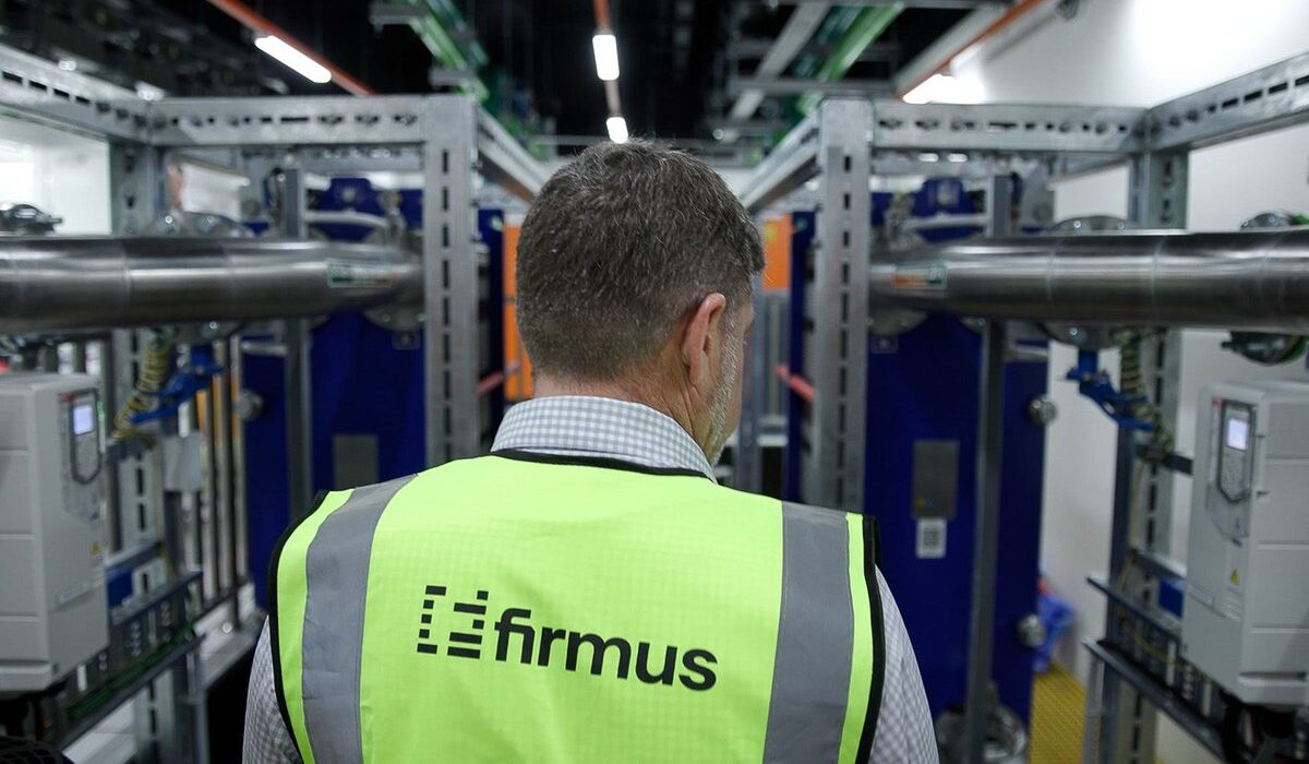 Firmus engineer inspecting cooling infrastructure inside an AI data center