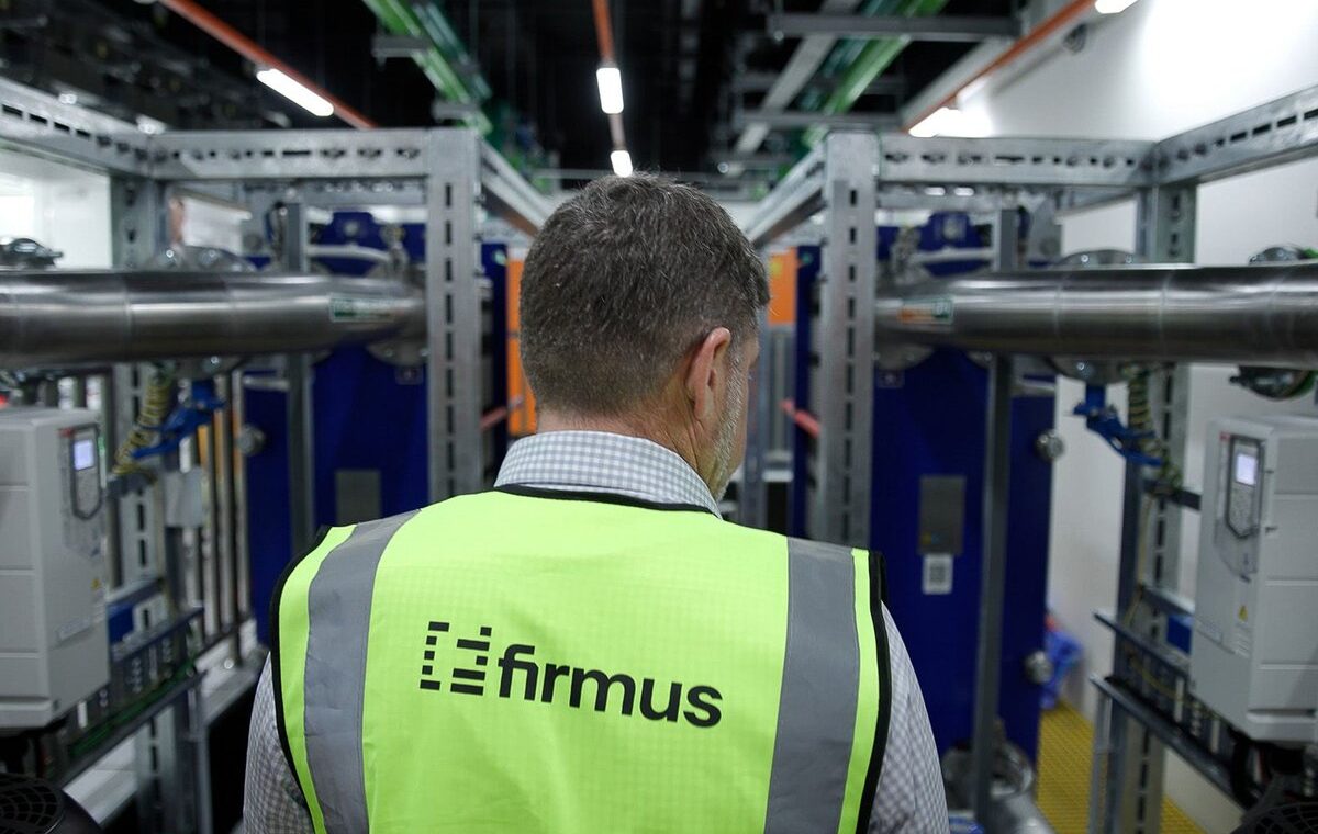 Firmus engineer inspecting cooling infrastructure inside an AI data center