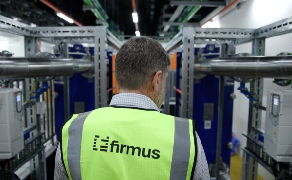Firmus engineer inspecting cooling infrastructure inside an AI data center