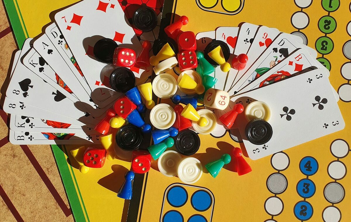 Colorful board game pieces, cards and dice