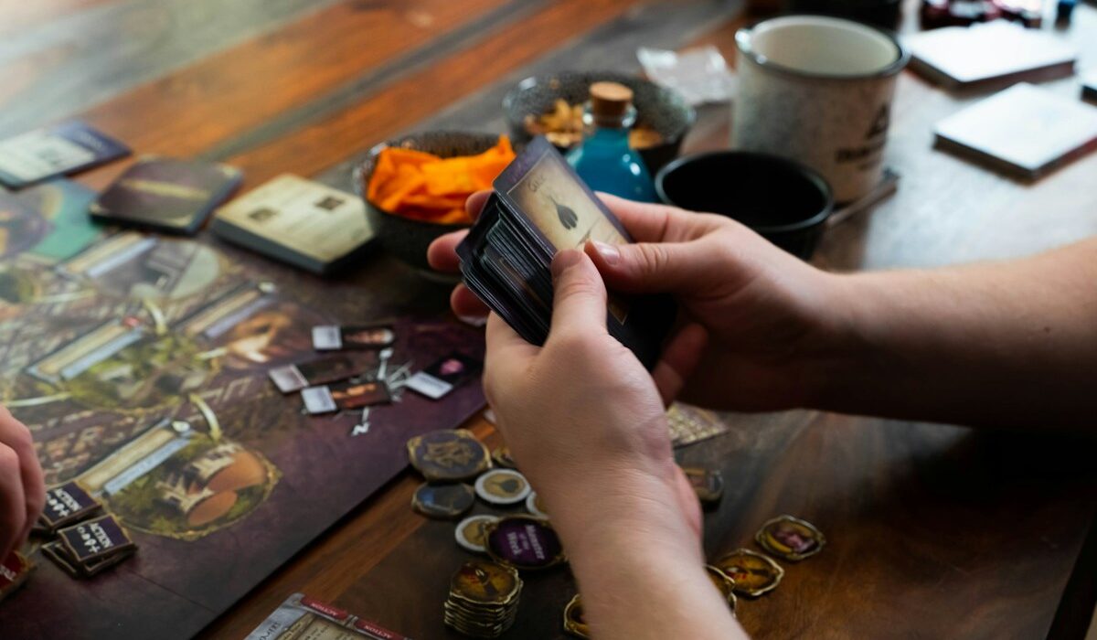 Player holding fantasy game cards representing Hasbro revenue and Magic sales