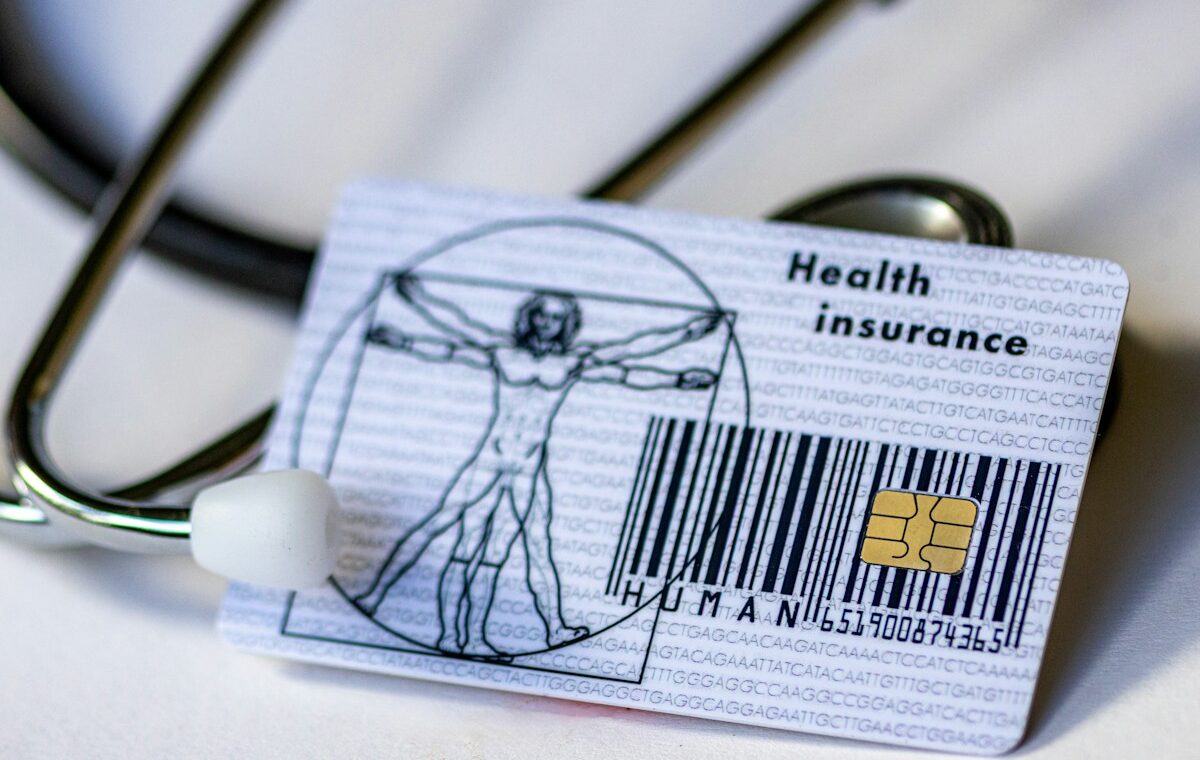 Health insurance card and stethoscope representing Molina Healthcare earnings