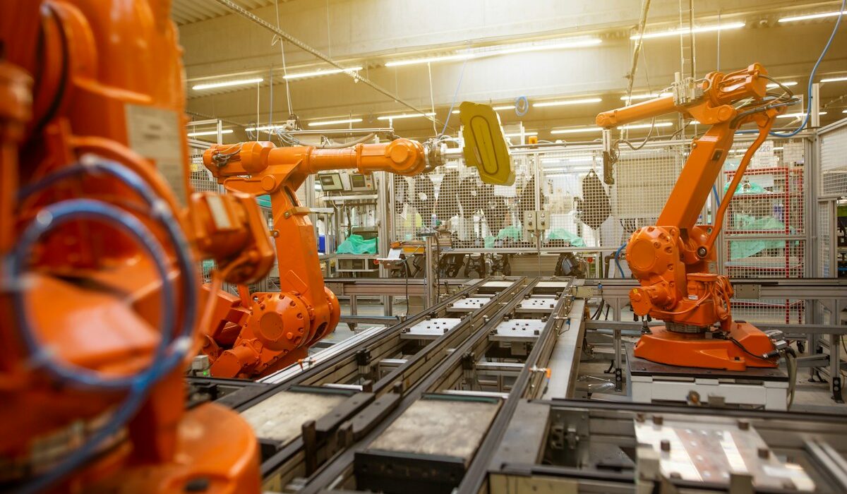 Industrial robots on a factory production line illustrating asset turnover