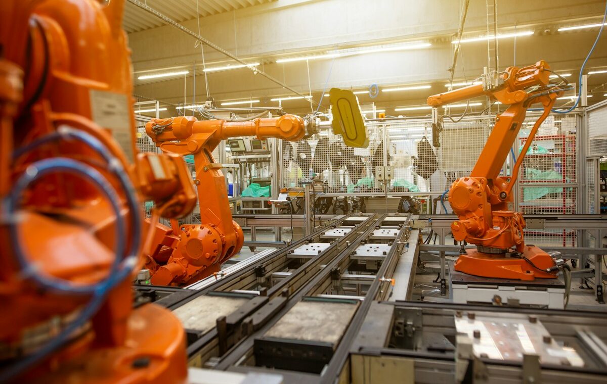 Industrial robots on a factory production line illustrating asset turnover