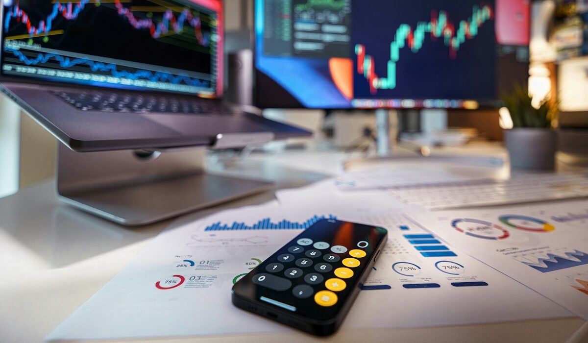 Financial market charts and calculator representing institutional RWA swaps