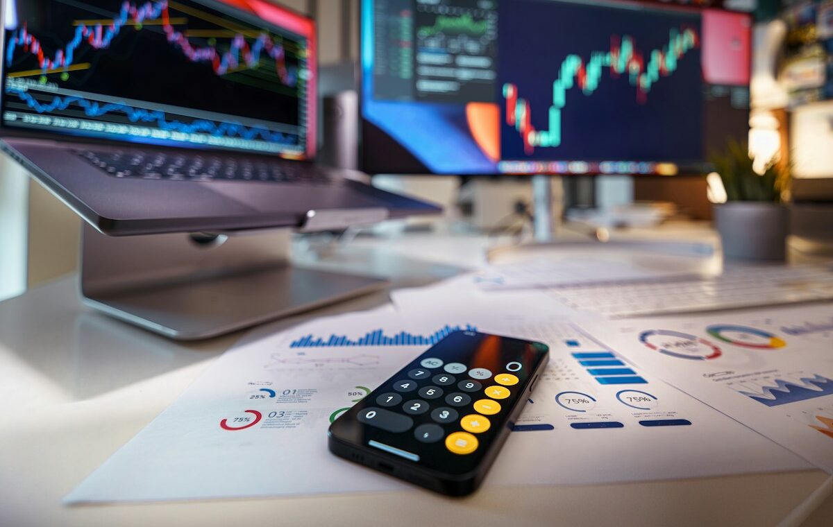 Financial market charts and calculator representing institutional RWA swaps